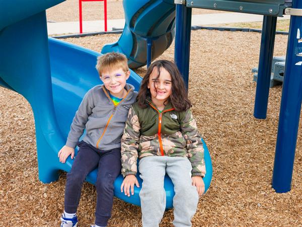 two students on slide
